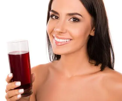 Ikaria Juice girl holding juice drink